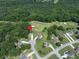 Aerial view of the property highlighting its prime location within a lush, green community and golf course at 49 Inverness Ct, Hiram, GA 30141