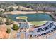 Aerial view of a beautiful community clubhouse, a scenic pond, and a parking lot in a quiet neighborhood at 49 Inverness Ct, Hiram, GA 30141