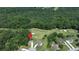 Aerial shot of a home nestled in a wooded lot near the golf course at 49 Inverness Ct, Hiram, GA 30141