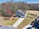 Aerial view featuring a home with a long driveway and a well-manicured front lawn at 49 Inverness Ct, Hiram, GA 30141