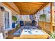 Relaxing covered porch with a floral rug, wicker furniture, and hanging plants at 49 Inverness Ct, Hiram, GA 30141