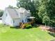 Expansive backyard featuring a wooden deck, fire pit, and charming wooden fence at 49 Inverness Ct, Hiram, GA 30141