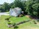 Aerial view of a large backyard featuring a deck, fire pit, and decorative wooden fence at 49 Inverness Ct, Hiram, GA 30141