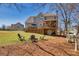 Expansive backyard with deck, fire pit, and ample space for outdoor activities at 49 Inverness Ct, Hiram, GA 30141