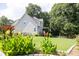 Charming backyard featuring lush landscaping, wooden fence, and a cozy deck, perfect for outdoor relaxation at 49 Inverness Ct, Hiram, GA 30141