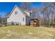 Well-maintained backyard featuring a deck, lush lawn, and a wooded backdrop at 49 Inverness Ct, Hiram, GA 30141