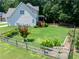 Well-manicured backyard with wooden fence, landscaping, and a covered deck at 49 Inverness Ct, Hiram, GA 30141