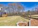 Expansive backyard featuring lush greenery, a wooden deck, and classic wood fence at 49 Inverness Ct, Hiram, GA 30141