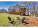 Large fenced backyard featuring a fire pit and scenic wooded view at 49 Inverness Ct, Hiram, GA 30141