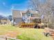 Spacious backyard with a deck, patio, manicured lawn, and wooded view at 49 Inverness Ct, Hiram, GA 30141