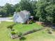 Aerial view of a fenced backyard with lush greenery and a well-maintained lawn, perfect for outdoor activities at 49 Inverness Ct, Hiram, GA 30141