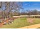 Beautiful backyard featuring firepit and wooded view and golf course at 49 Inverness Ct, Hiram, GA 30141