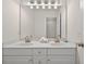 Bathroom with a double vanity, large mirror and bright lighting at 49 Inverness Ct, Hiram, GA 30141