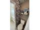 Cozy bathroom design featuring elegant floral wallpaper, a toilet, and towel racks for convenience at 49 Inverness Ct, Hiram, GA 30141
