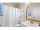 Clean bathroom with a white vanity, gold mirror, and a shower with a white curtain at 49 Inverness Ct, Hiram, GA 30141