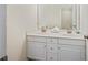 Well-lit bathroom features modern sink, white cabinets and large mirror at 49 Inverness Ct, Hiram, GA 30141