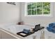 Soaking tub with caddy, towels, and window view at 49 Inverness Ct, Hiram, GA 30141