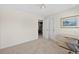 Bedroom showcasing neutral decor, carpet, closet, and convenient access to the laundry area at 49 Inverness Ct, Hiram, GA 30141