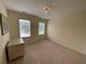 Empty bedroom features a modern light fixture and neutral colored walls and floors at 49 Inverness Ct, Hiram, GA 30141
