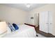 Bright bedroom showcases a bed with blue accents, wood-look flooring, and closet doors at 49 Inverness Ct, Hiram, GA 30141