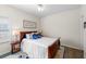 Cozy bedroom features stylish decor and a large window for natural light at 49 Inverness Ct, Hiram, GA 30141