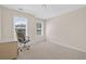 Bright bedroom featuring neutral walls, carpeted floors, with two sunlit windows and a modern desk at 49 Inverness Ct, Hiram, GA 30141