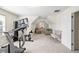 Spacious bonus room with neutral carpet, comfortable seating, and a home gym area at 49 Inverness Ct, Hiram, GA 30141