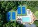 Aerial view of community amenities including two tennis courts, a swimming pool, and a clubhouse at 49 Inverness Ct, Hiram, GA 30141