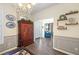 Foyer with chandelier, decorative shelves, a storage cabinet, and wood flooring at 49 Inverness Ct, Hiram, GA 30141