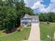 Stunning exterior view of the home with a well-manicured lawn, charming blue shutters, and inviting entrance at 49 Inverness Ct, Hiram, GA 30141