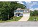 Charming two-story home with blue shutters, white trim and a well-manicured lawn on a sunny day at 49 Inverness Ct, Hiram, GA 30141