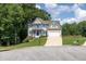 Charming two-story home with blue shutters, white trim and a well-manicured lawn on a sunny day at 49 Inverness Ct, Hiram, GA 30141