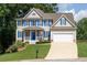 Charming two-story home with blue shutters, white trim, inviting porch, and well-manicured lawn at 49 Inverness Ct, Hiram, GA 30141
