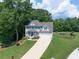 Beautiful home exterior showcasing a well-maintained yard, blue shutters, and a welcoming front entrance at 49 Inverness Ct, Hiram, GA 30141