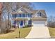 Inviting two-story home with blue shutters, lush lawn, and an attached two-car garage at 49 Inverness Ct, Hiram, GA 30141