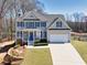 Charming two-story home with manicured lawn, blue shutters and an attached two car garage at 49 Inverness Ct, Hiram, GA 30141