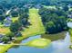 Beautiful aerial view of the community golf course featuring lush green fairways and scenic water hazards at 49 Inverness Ct, Hiram, GA 30141