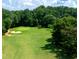 Picturesque golf course with mature trees, sand trap, and manicured green at 49 Inverness Ct, Hiram, GA 30141