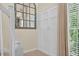 Hallway with wainscoting, view of natural light, and carpeted floor at 49 Inverness Ct, Hiram, GA 30141