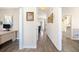 Hallway with hard floors, neutral paint, and an entrance to the home office on the left at 49 Inverness Ct, Hiram, GA 30141