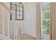 Hallway with wainscotting, staircase, and a decorative mirror at 49 Inverness Ct, Hiram, GA 30141