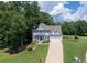 Inviting two-story home boasts a well-kept lawn, attached garage, and a charming blue front door at 49 Inverness Ct, Hiram, GA 30141