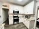 Stylish kitchen featuring white cabinets, granite countertops, and stainless steel appliances at 49 Inverness Ct, Hiram, GA 30141