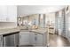 Well-lit kitchen with stainless steel dishwasher and sink, granite countertops, and an adjacent breakfast nook at 49 Inverness Ct, Hiram, GA 30141