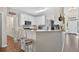 Eat-in kitchen with granite countertops, stainless steel appliances, white cabinetry, and breakfast bar at 49 Inverness Ct, Hiram, GA 30141