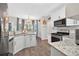 Bright, updated kitchen with granite counters, stainless appliances, white cabinets, and a view of the sink at 49 Inverness Ct, Hiram, GA 30141