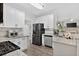 Bright kitchen featuring stainless steel appliances and granite countertops at 49 Inverness Ct, Hiram, GA 30141