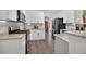 Bright kitchen featuring white cabinets, stainless steel appliances, and granite countertops at 49 Inverness Ct, Hiram, GA 30141