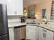 Well-lit kitchen with granite counters, stainless appliances, and view into a living room at 49 Inverness Ct, Hiram, GA 30141