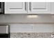 Close-up of a kitchen backsplash with white subway tiles and granite countertops at 49 Inverness Ct, Hiram, GA 30141